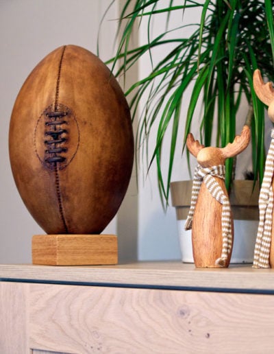 Old camel rugby ball displayed on top of a kitchen unit