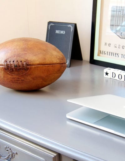 The old rugby ball lies flat on a desk