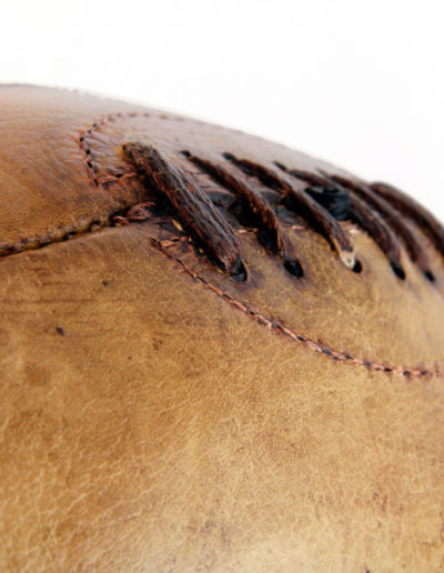 Presentation of a vintage rugby ball on a white background