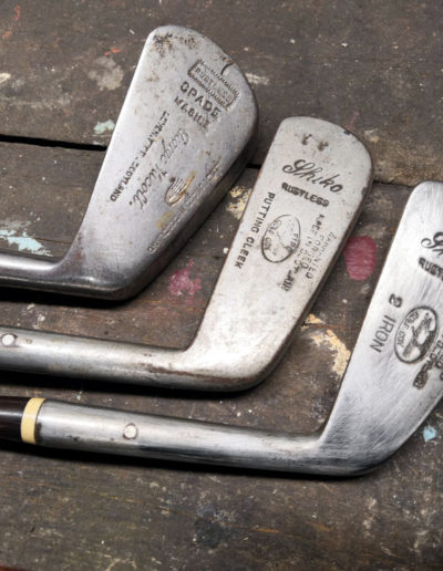 3 heads of old golf clubs with their writing