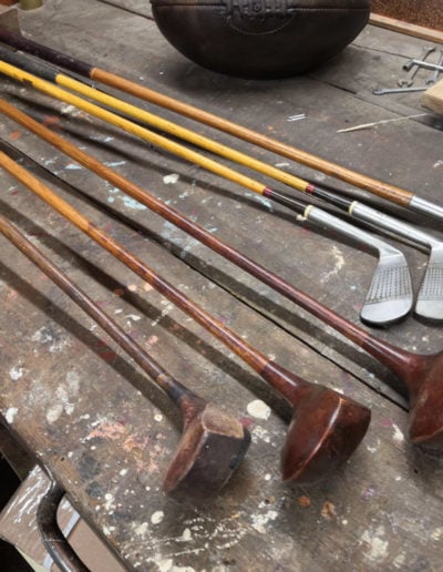 3 irons and 3 woods presented face to face on a workshop