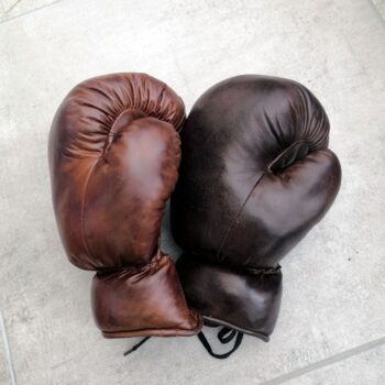 2 antique boxing gloves in 2 different colours