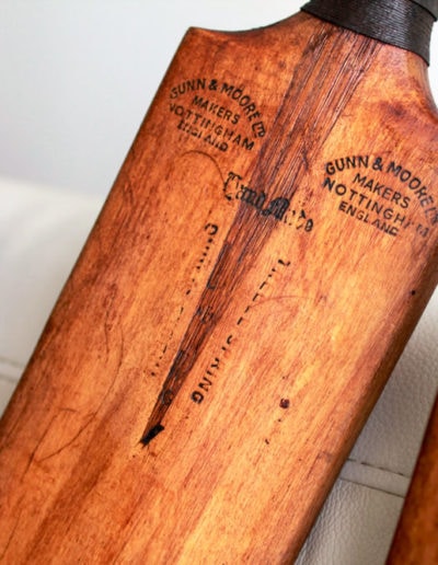 An antique cricket bat on the sofa