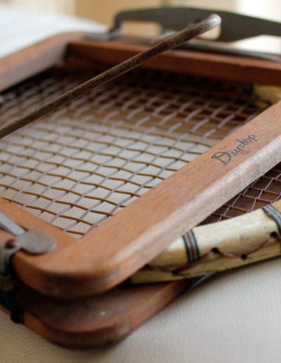 wooden frame of a vintage tennis racket