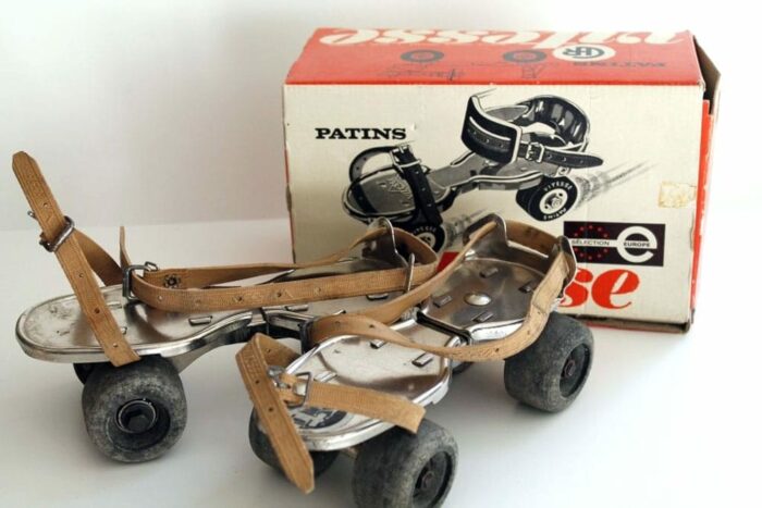 Pair of vintage roller skates with cardboard box