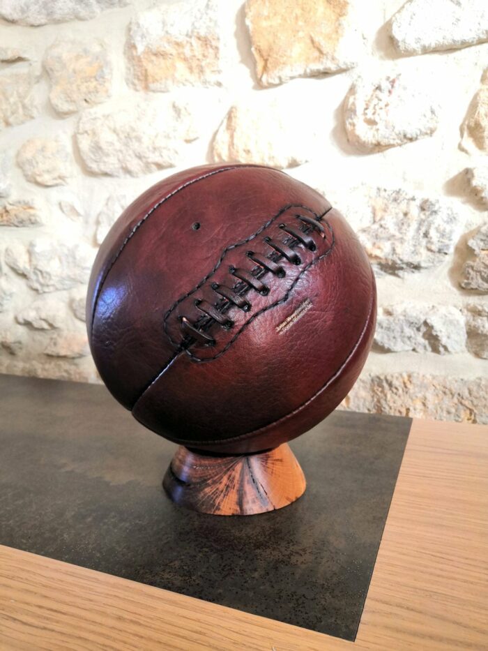 An old basketball on an oak base