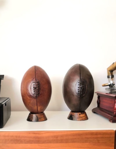 2 leather rugby balls used for vintage decoration