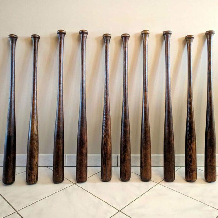 square photo of old baseball bats with exotic brown colors