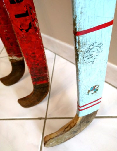 An old turquoise blue field hockey stick