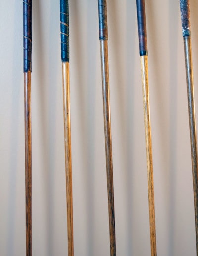 View of several wooden shafts of golf clubs