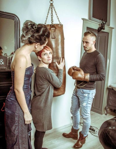 Leather punching bag photo shoot in the hands of a groom's mother