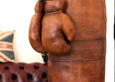 Leather punching bag with brown gloves