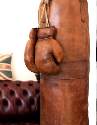 Leather punching bag with brown gloves