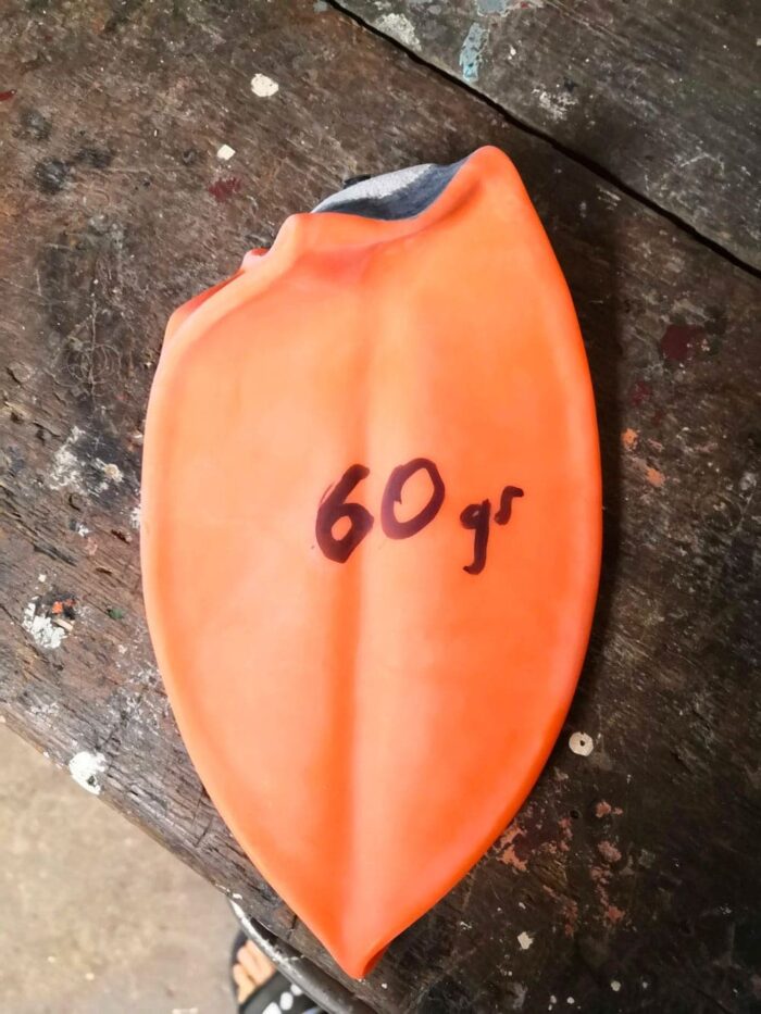 An orange latex soccer ball inner tube