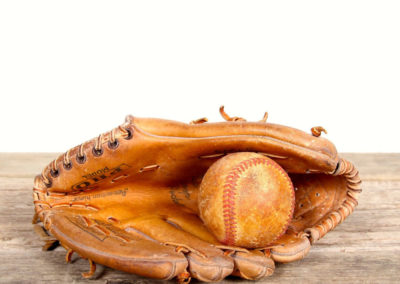 Example of an old baseball glove with its ball