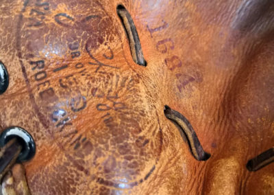 Logo on an old brown leather baseball glove