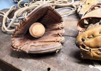 A pale leather baseball glove on an old workshop.