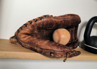 Baseball glove on a wooden shelf