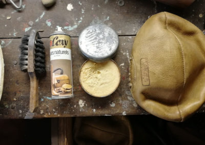 Brushing and polishing a leather ball