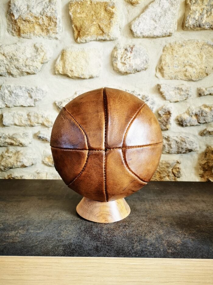 Ballon de basket vintage en cuir havane sur son socle