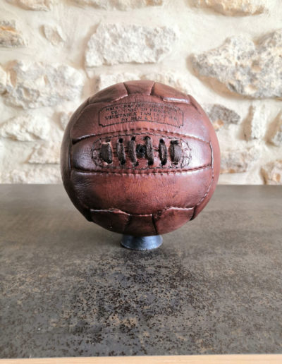 Old handball on its wooden base