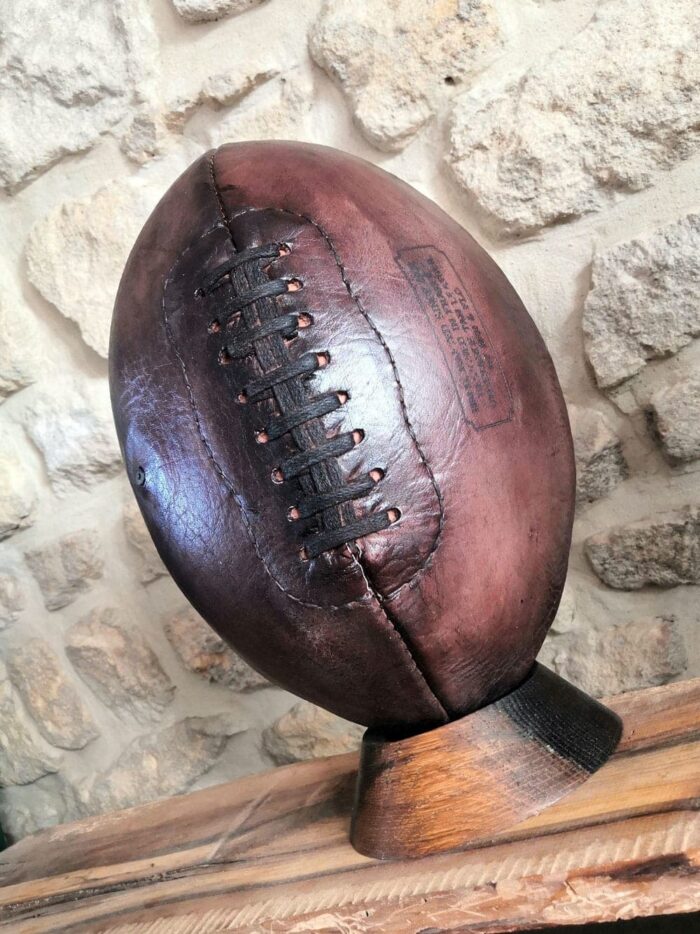 An American football displayed on a piece of furniture