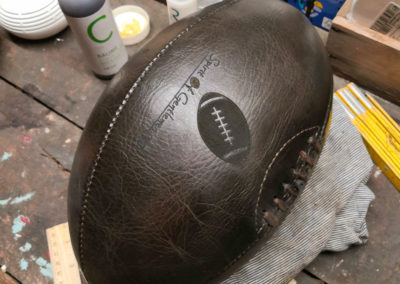 Logo engraving on a rugby ball