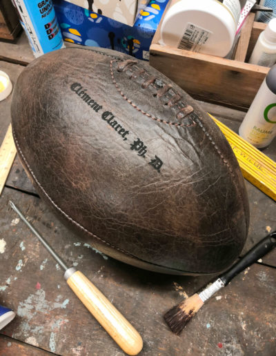 Engraving of name and surname on a vintage rugby ball