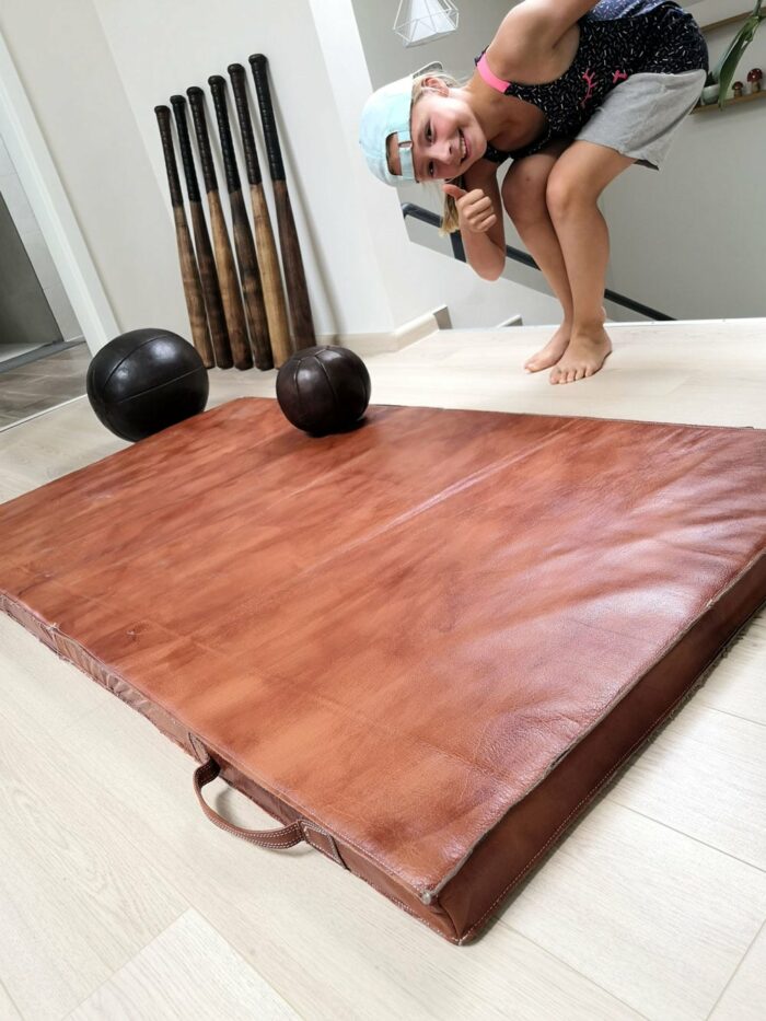 Old fitness mat with a little girl