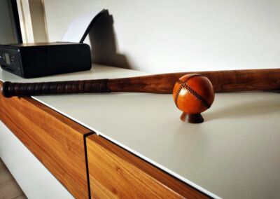 A single antique baseball on a piece of furniture