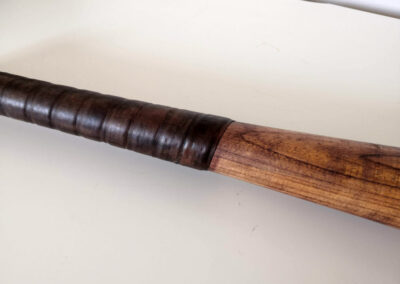 Leather grip of a vintage wooden baseball bat