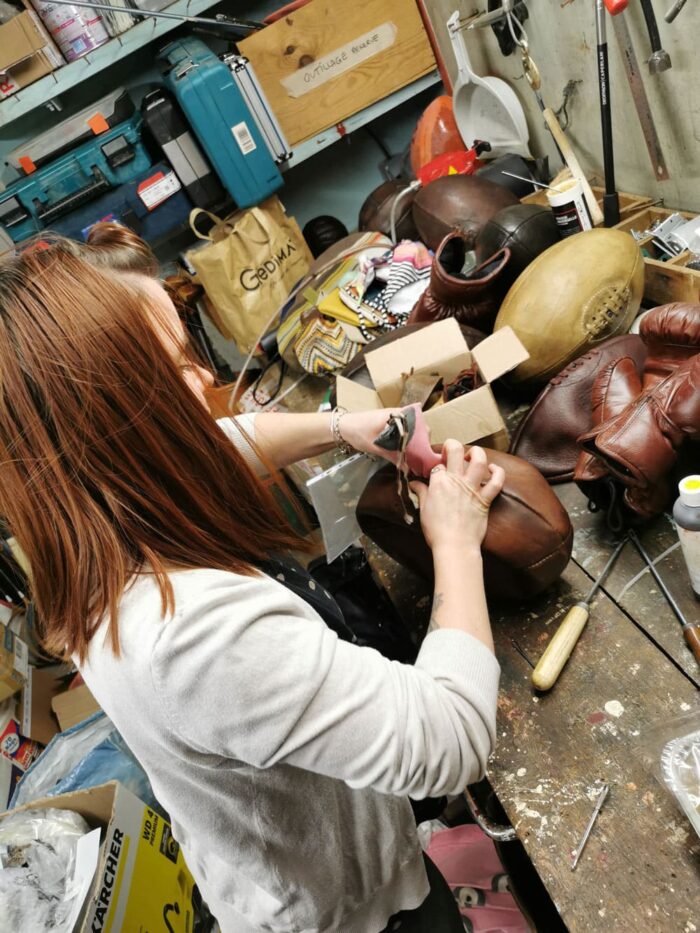 Marine repairs a rugby ball in the workshop